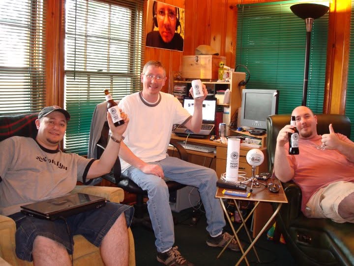Three people seated together in a recording room.